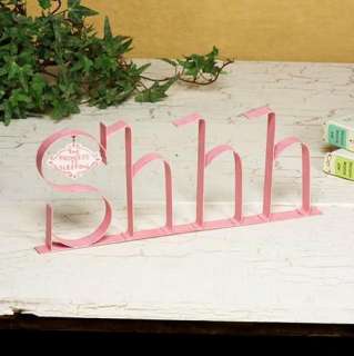   decor made of painted strap metal with large letters forming the