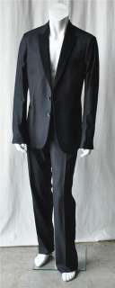 ultra modern tuxedo inspired suit with a suede peak lapel and sleeves 