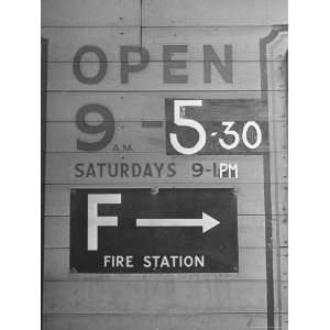  Sign Repainted to Show Earlier Closing Time For a Business 