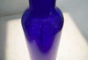 beautiful royal blue color with cursive writing on the bottle writing 